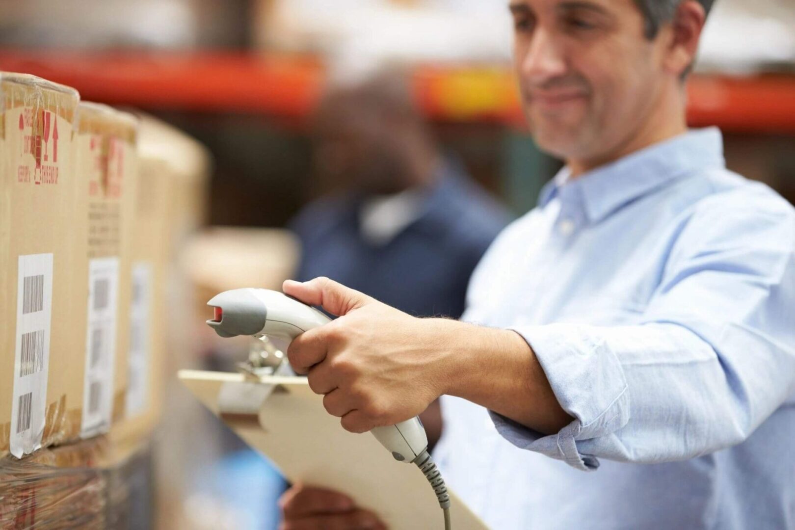 A man holding a wii controller in his hand.