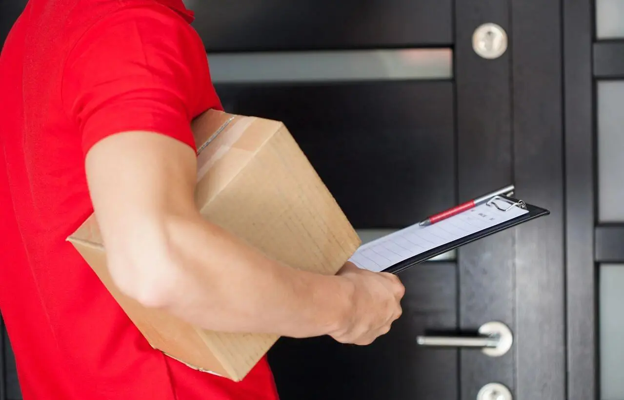 A person holding a box and a ruler