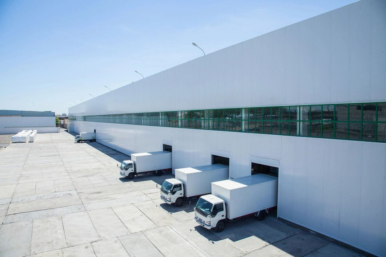 A group of trucks parked in front of a building.